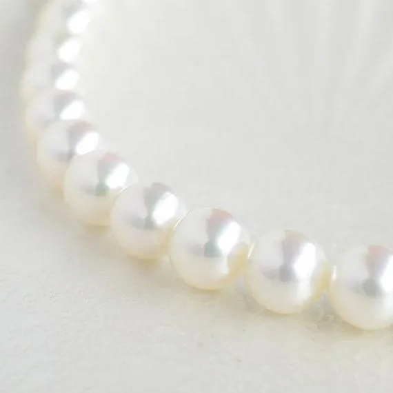 Close view of a matched white Akoya pearl strand with bright luster