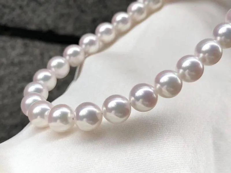Round white Akoya pearls in a necklace