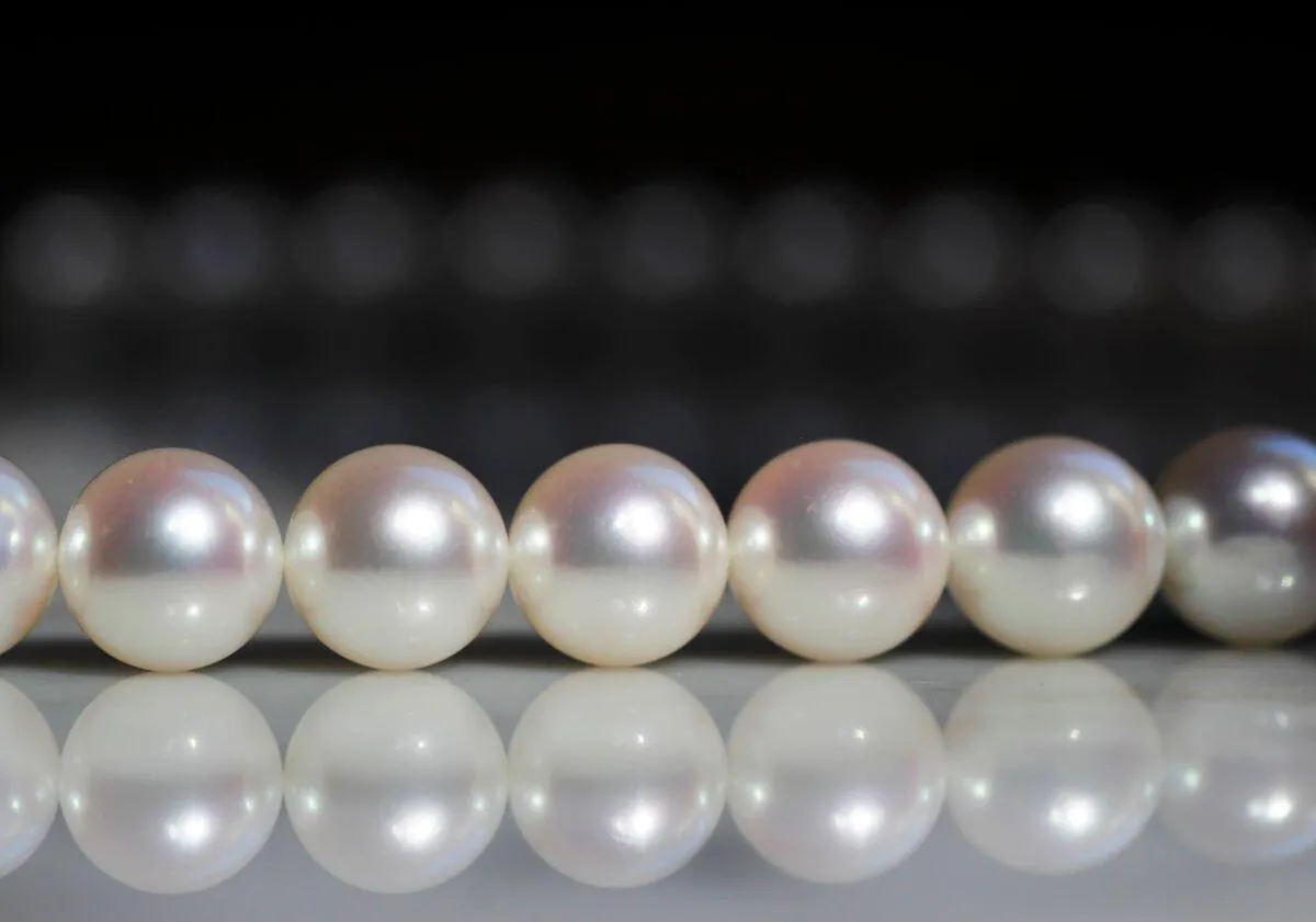 White Akoya pearl strand showing bright reflected highlights