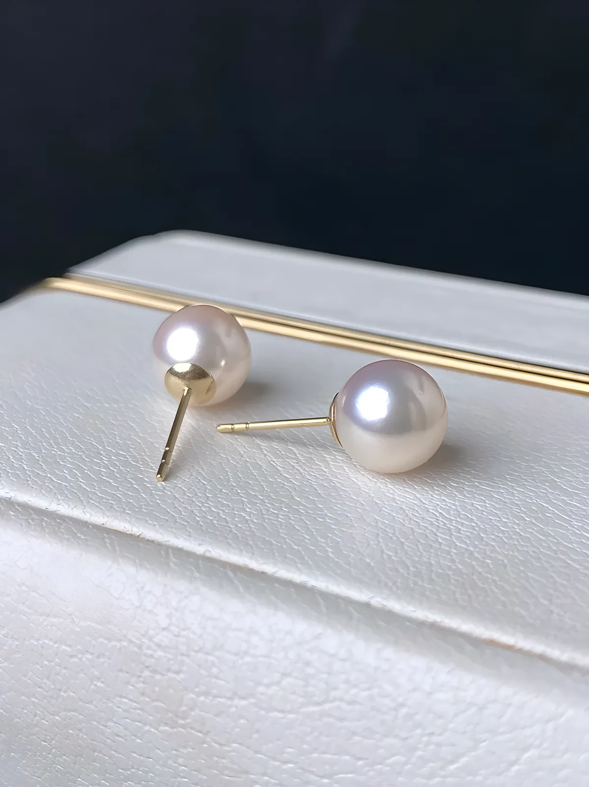 white pearl stud earrings on box