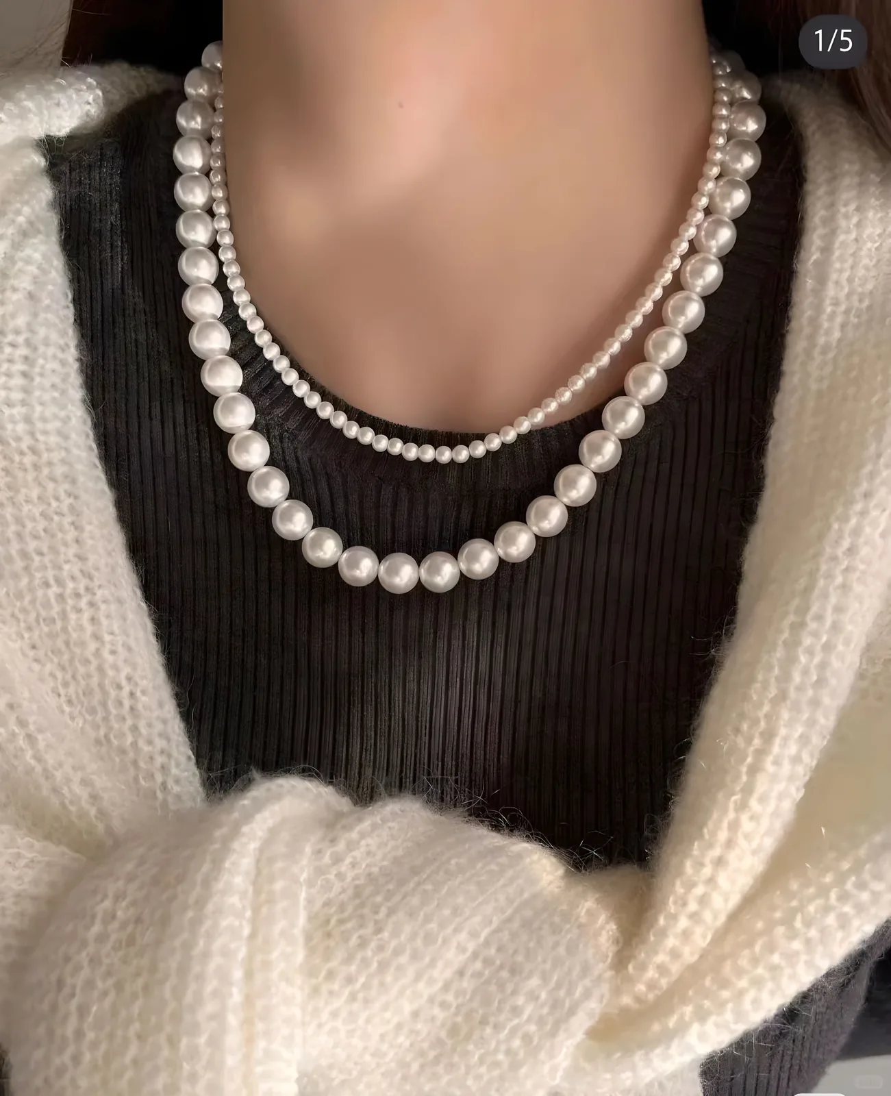 Two white pearl necklaces layered at different lengths