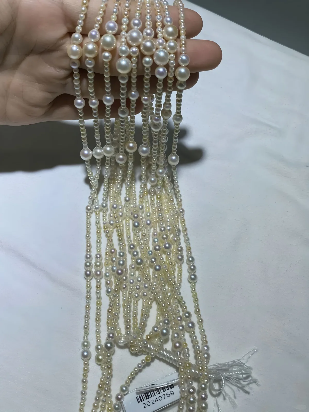 white pearl strands held in hand