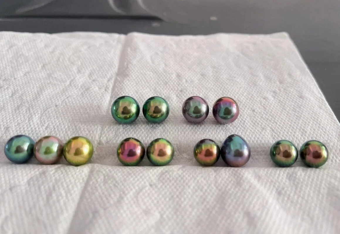 dark cultured pearls showing color-enhanced appearance from dyeing or irradiation treatment