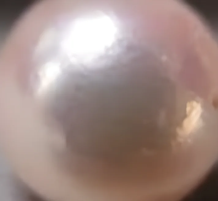 Close-up detail of Akoya pearl luster and surface reflection