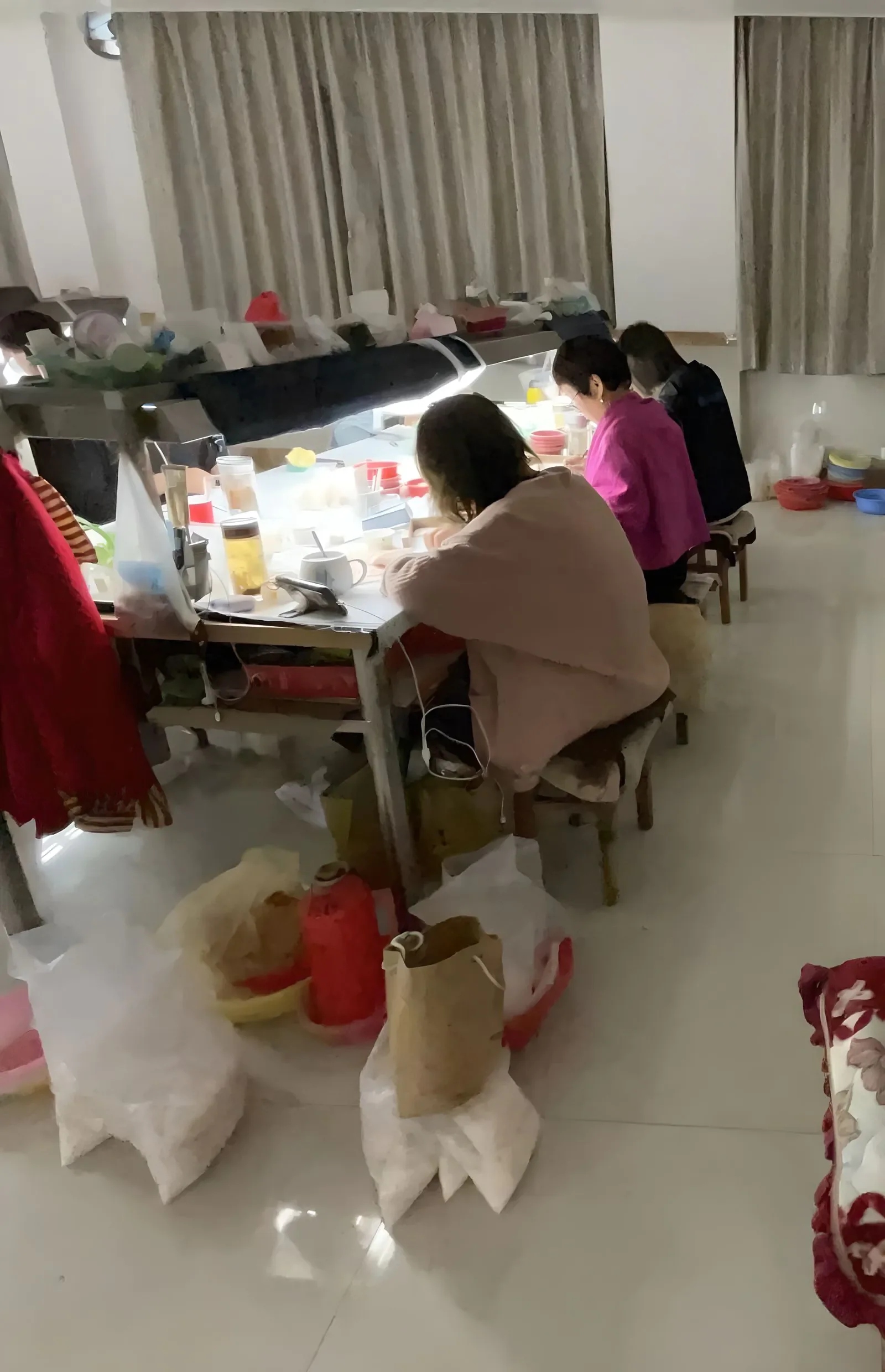 Pearl artisan preparing jewelry under inspection lights