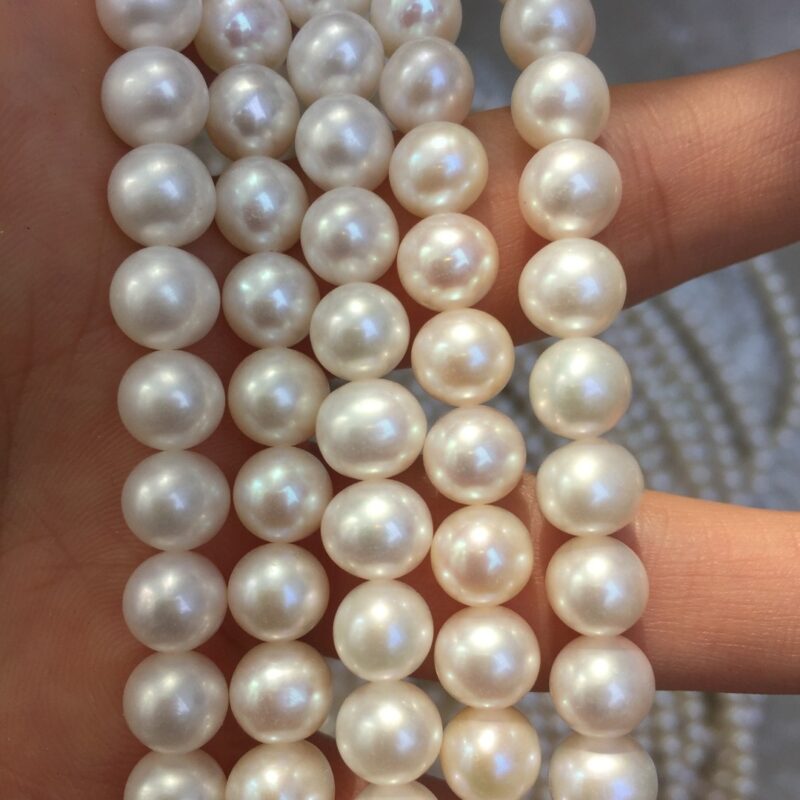 Close-up of real pearls showing layered luster and slight natural surface variation