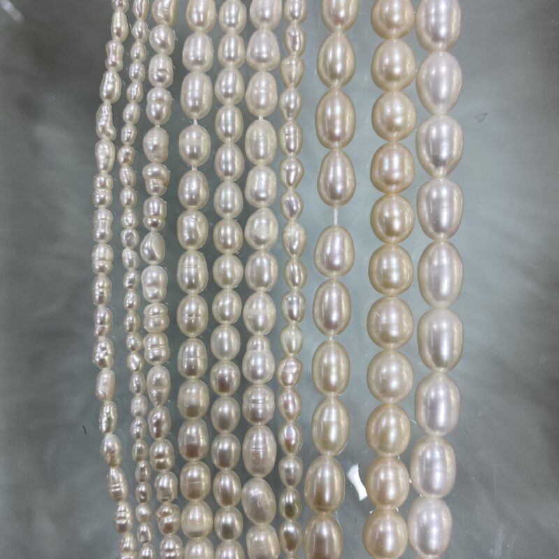 Multiple grades of freshwater cultured pearls sorted by shape and surface quality