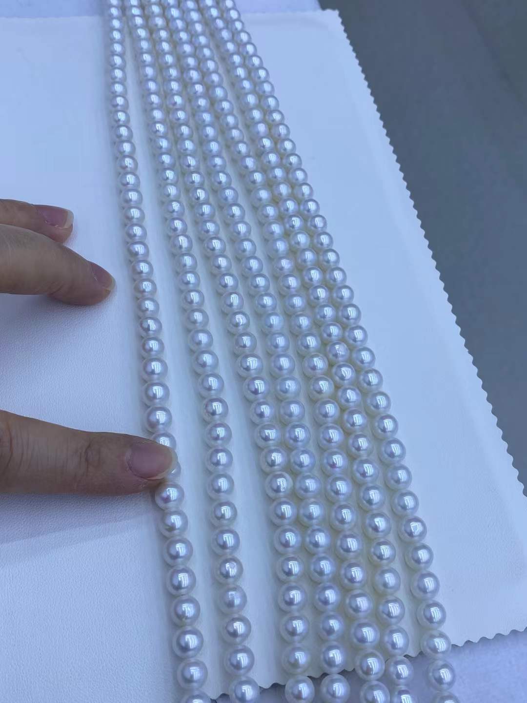 clean close-up photo of white or pastel freshwater pearl strands.